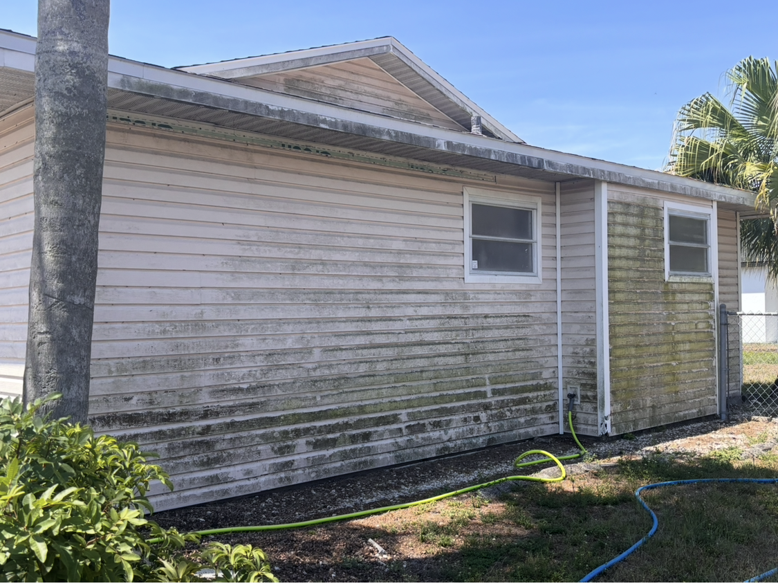 Before: House exterior with mold and algae buildup - Lehigh Acres pressure washing