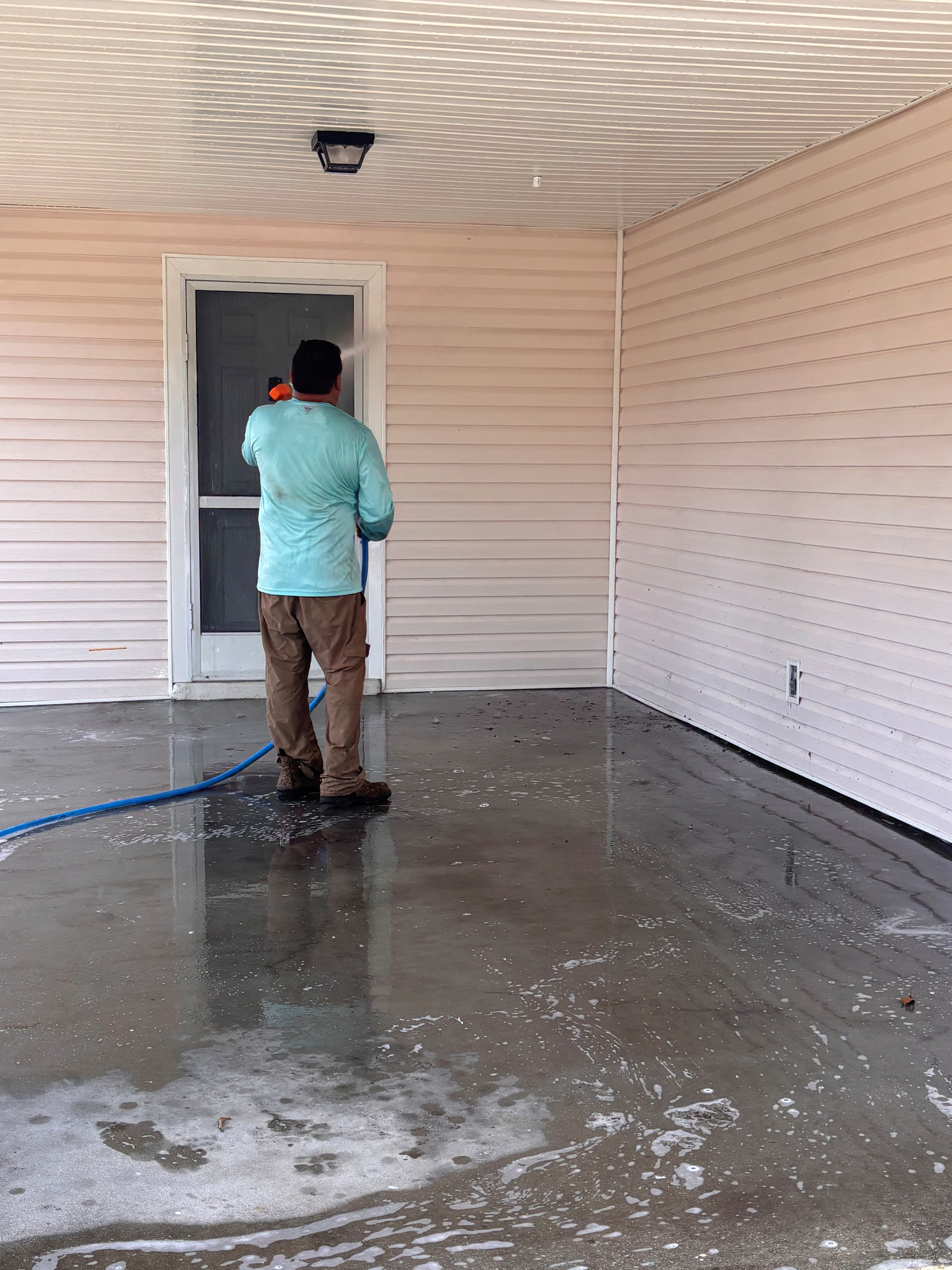 RCW crew pressure washing a large driveway